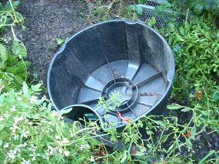 empty mini water tank stand used for pond about 2 foot long and crescent shaped