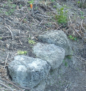 a seat made from basalt rocks placed in side of hill